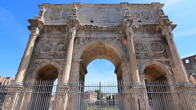 rome,roman constantine arch beside colosseum tilt daylight blue sky