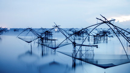 Silhouette of traditional fishing method using a bamboo square d