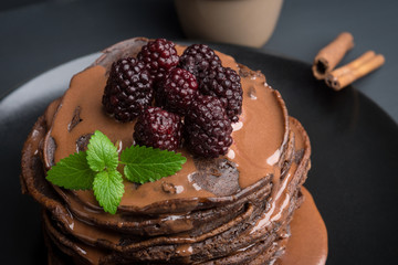 Stack of pancakes with fresh blackberries. Shallow depth of field.