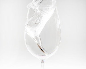 Water splashes when a coin money dropped in to a glass