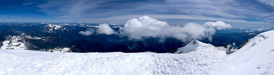 Mountains, Snow, Sky and Clouds. Breathtaking view from Mount Baker summit,  North Cascades National Park, Washington State, USA. 