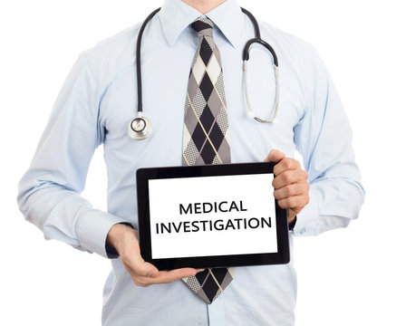 Doctor holding tablet - Medical investigation