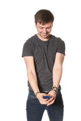 Casual young man with light beard, taking selfie on mobile phone,  isolated on white