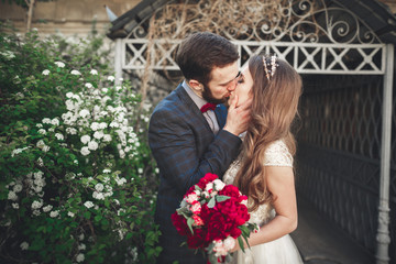 Kissing wedding couple in spring nature close-up portrait