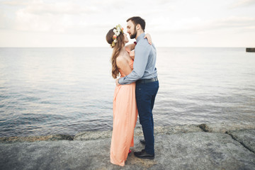 Wedding couple, bride, groom walking and posing on pier