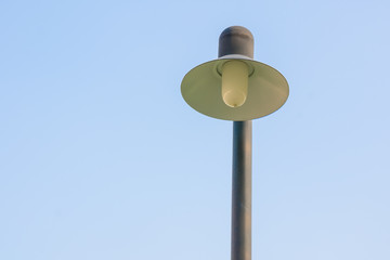 Old classic vintage street light against the blue sky