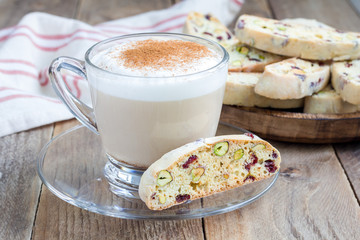 Biscotti with cranberry and pistachio, cup of coffee latte