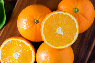 Fresh organic oranges fruits on wooden background.