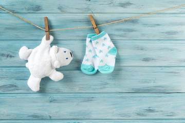 White toy bear and baby socks with stars print on a clothesline