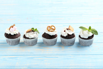 Chocolate cupcakes on a blue wooden table