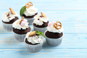 Chocolate cupcakes on a blue wooden table