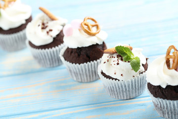 Chocolate cupcakes on a blue wooden table