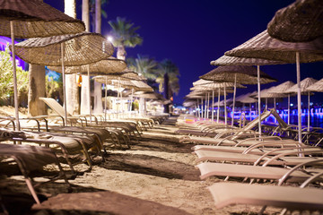 Sunbeds and umbrellas on the beach in the evening