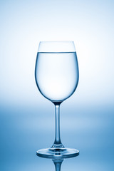 Glass of water isolated on white and blue background