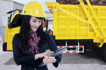 Businesswoman and truck carrying palm fruit