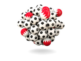 Pile of footballs with flag of bahrain