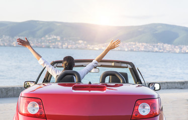 Relaxing woman on the beach in the car.