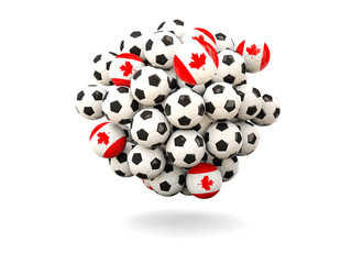 Pile of footballs with flag of canada
