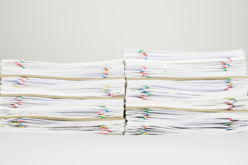 Fototapeta premium Pile of overload paperwork and envelope on white background