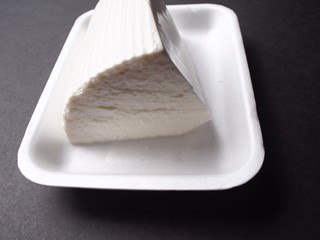 Fresh cheese on black background