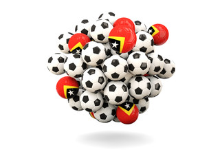 Pile of footballs with flag of east timor
