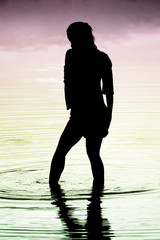 silhouette of a girl standing in water