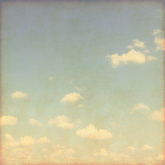 Blue sky with clouds in grunge style.
