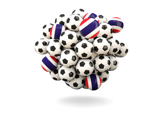 Pile of footballs with flag of thailand