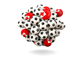Pile of footballs with flag of tonga