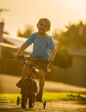 smiling child on a bike