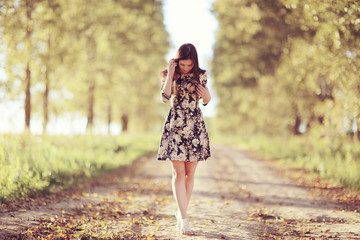 Girl in dress on the summer road