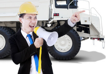 Worker screaming with megaphone and truck