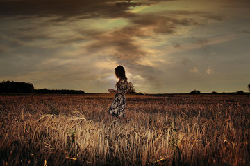 girl in the sunset cloudy sky Field