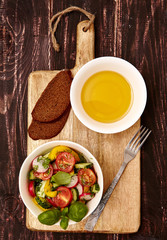 Vegetarian healthy food sontsept . salad with fresh organic vegetables, olive oil and bread. Top view