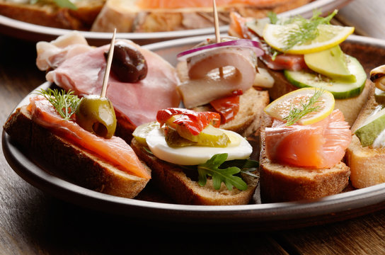 Open sandwiches with salmon, eggs, mussels, jamon and herring
