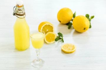 Italian traditional liqueur limoncello with lemon