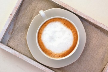 Cappuccino in the cup on the cloth
