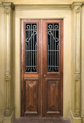 Vintage wooden brown door with glass and metal  ornate grid