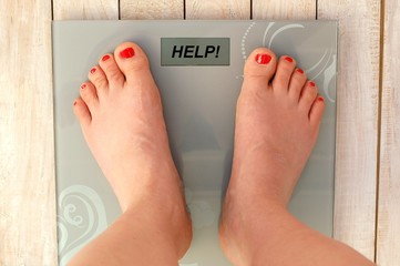 Feet on scales with text help in English language