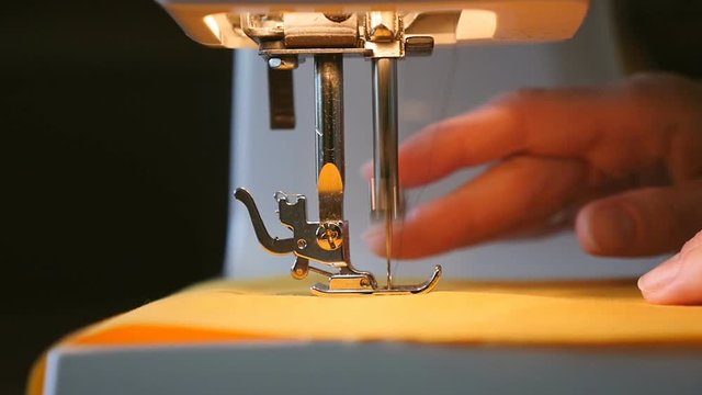 Woman sewing on the sewing machine - slow motion