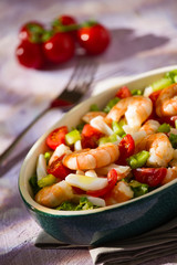 Salad of shrimps inside an oval bowl