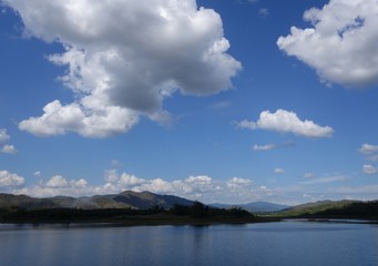 Scenic view of small reservoir with blue sky background in Sukhothai province, Thailand