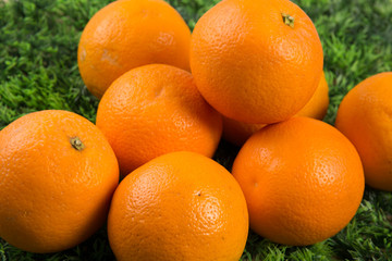 Lots of Fresh orange fruits on green grass