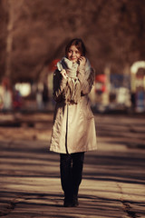 spring photo beautiful girl in a coat in the city