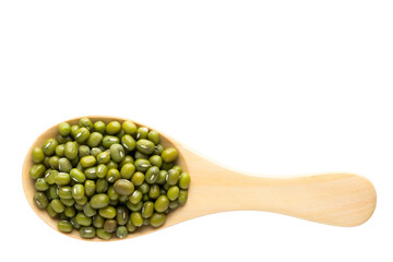 Green bean whole grain on the wooden spoon. top view