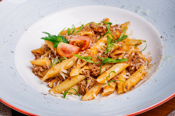 pasta nautically with minced meat on wood table