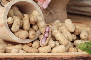 Peanut and boiled peanuts on wood background.