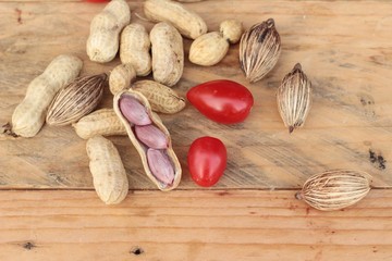 Peanut and boiled peanuts on wood background.