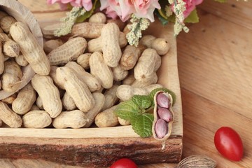 Peanut and boiled peanuts on wood background.
