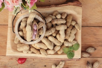 Peanut and boiled peanuts on wood background.